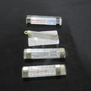 Assorted thermometers, four total, varying sizes, clear casings with Celsius and Fahrenheit scales, condition moderate.