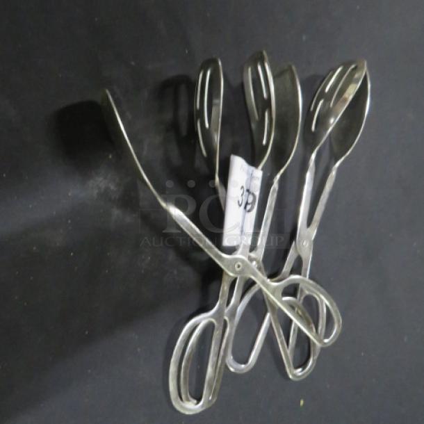 Stainless steel tongs, model 3XBID, featuring a sleek design and ergonomic handles, in excellent condition.