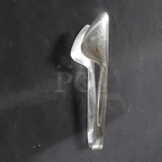 Stainless steel tong, polished finish, moderate wear, featuring a robust grip design. Marked "5XBID."