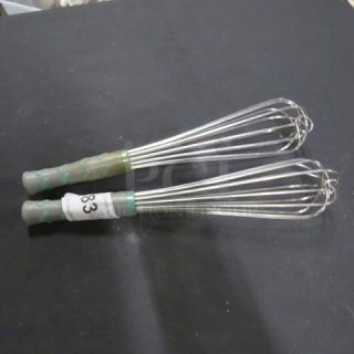 Two commercial whisks with gray and green handles, labeled "83," in excellent condition, ideal for professional kitchens.