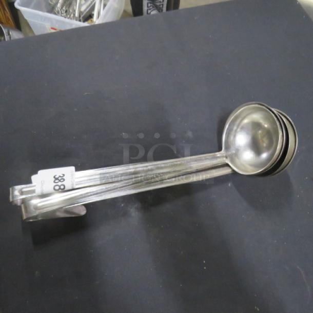 8oz stainless steel ladle, model 4XBID, in good condition. Features a smooth bowl, long handle, and visible lot tag "388".