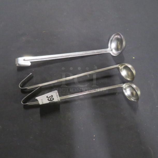 Assorted stainless steel ladles, three pieces, various sizes. Includes hooks for hanging. Visible label marked "39C".