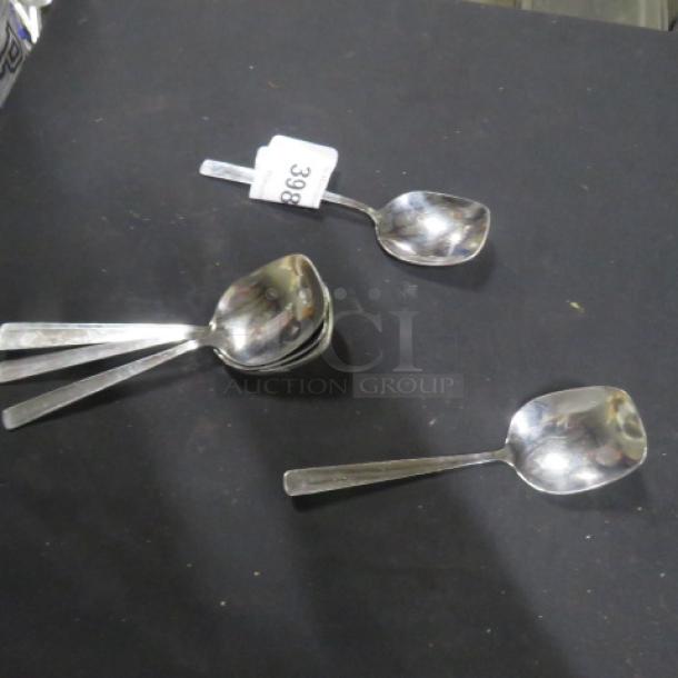 Lot of 8 stainless steel serving spoons, sleek design, reflective finish, tag labeled "398." Good condition.