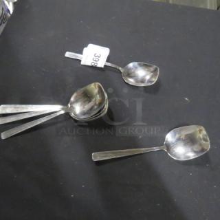 Lot of 8 stainless steel serving spoons, sleek design, reflective finish, tag labeled "398." Good condition.