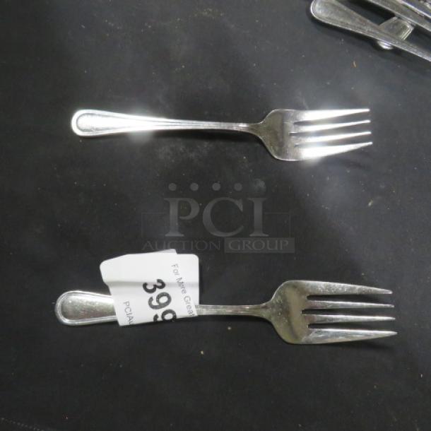 14 stainless steel serving forks, polished finish, excellent condition. Auction lot tag shows number 399.
