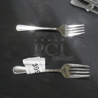 14 stainless steel serving forks, polished finish, excellent condition. Auction lot tag shows number 399.