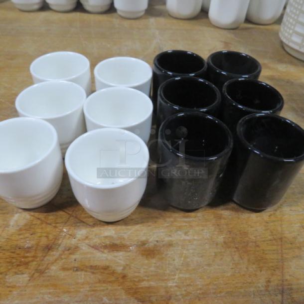 Assorted sake cups, 12-piece set, white and black ceramic. Clean condition, ideal for collectors or beverage enthusiasts.