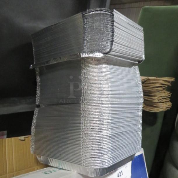 One lot of 1/2 size 2.5-inch aluminum pans with lids, stacked, showing clean and unused condition.