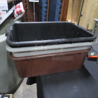 Assorted bussing tubs, three stackable pieces; used condition; black, gray, and brown colors; ideal for kitchen use.