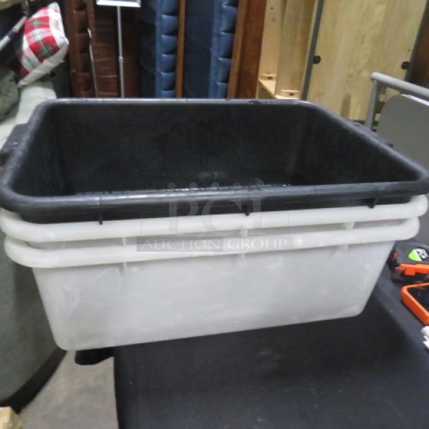 Assorted bussing tubs, black and white, stacked, used condition, ideal for kitchen or restaurant use, model 3XBID.