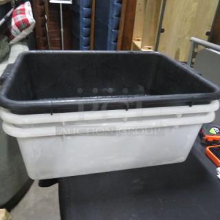 Assorted bussing tubs, black and white, stacked, used condition, ideal for kitchen or restaurant use, model 3XBID.