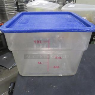 Clear 12 quart food storage container with blue lid, marked with liter and quart measurements, used condition.