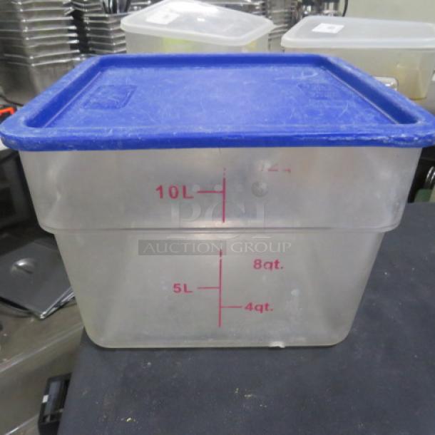 Clear 12 Qt food storage container with blue lid, marked with liter and quart measurements. Used condition.