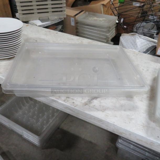 A transparent 5-gallon food storage container with lid, shown on a countertop, in good condition.