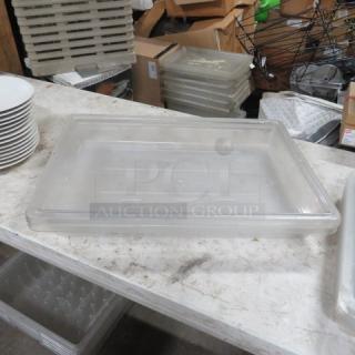 Clear rectangular food storage container, approximately 5-gallon capacity, used condition, stackable design, no visible labels.