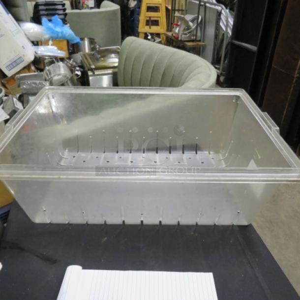 Clear 18x26x8 perforated food storage container in good condition, suitable for commercial kitchen use.