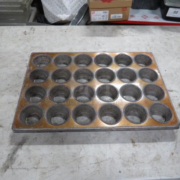24 hole commercial muffin pan, metal, used condition, slight discoloration, ideal for bakery use, model 2XBID.