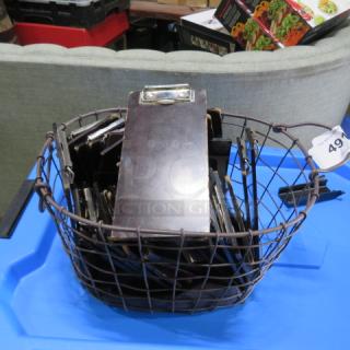 Wire basket filled with check presenters, featuring metal clips. Condition appears used. Auction tag number 49 attached.