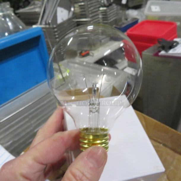 A clear 40-watt bulb held in hand, part of a case, against a backdrop of industrial shelving.