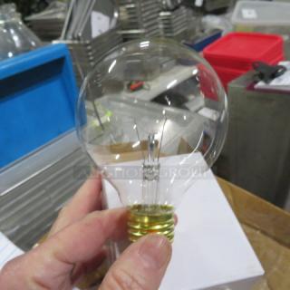 A clear 40-watt bulb held in hand, part of a case, against a backdrop of industrial shelving.