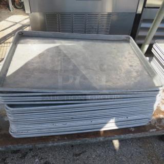 Stack of full-size sheet pans, 5XBID. Used condition, metal construction, standard dimensions, scuff marks visible.