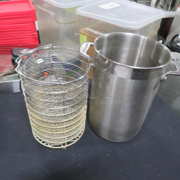 Stainless steel All Clad pasta cooker with basket, featuring sturdy handles, excellent condition, ideal for cooking pasta.