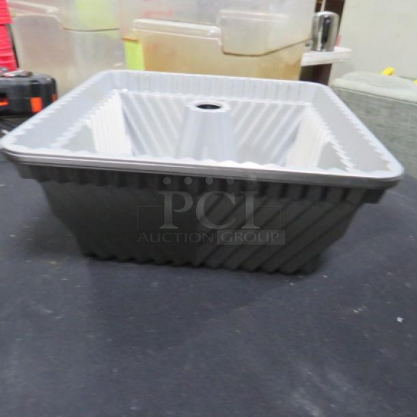 Square Bundt pan, 8.5x8.5x4 inches, with fluted inner edges, in good condition, ideal for baking decorative cakes.