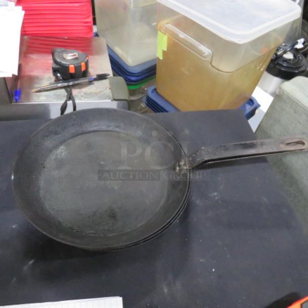 LODGE 12-inch cast iron sauté pan in used condition. Features a sturdy handle and seasoned surface, ideal for versatile cooking.