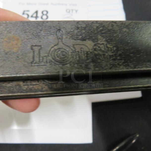 LODGE 12-inch sauté pan, cast iron, used condition with visible rust on handle. Logo embossed on handle: "Lodge."