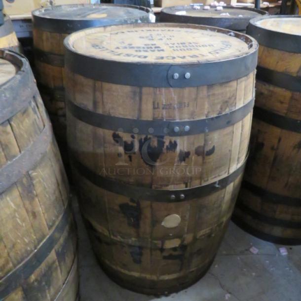Buffalo Trace whiskey barrel, wooden with metal bands, used condition, markings indicating authenticity and origin.