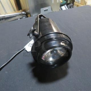 One Pin Spot Light with Mounting Bracket, Model PIN-130, 120 Volt, black finish, shown in good condition.