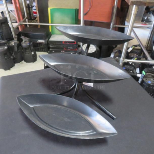 Black metal 3-tier buffet server with canoe-shaped melamine food holders; used condition.