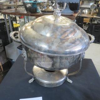 Round silver plate chafing dish with lion's head handles and lid; vintage condition, ornate detailing on base.