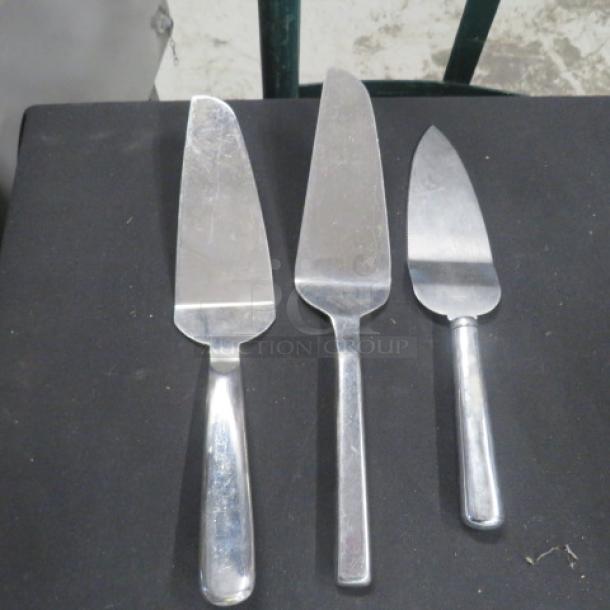 Assorted pie servers, stainless steel, set of three, slightly used condition. Different blade shapes for versatile serving.