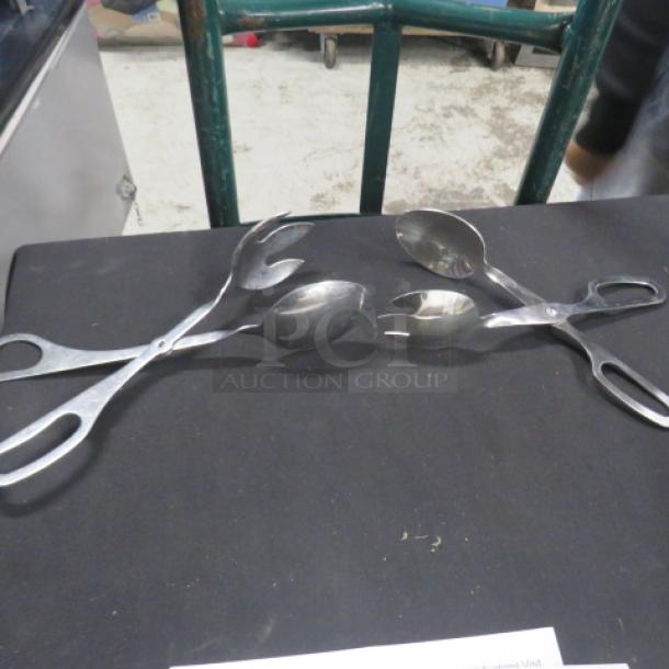 Stainless steel buffet tongs with scissor handles, set of two. Good condition, ideal for serving. Marked "4XBID".