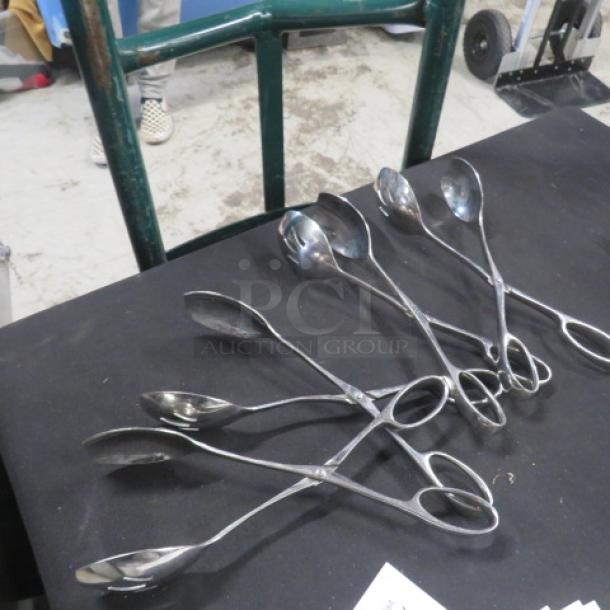 Stainless steel buffet tongs, six pieces, sleek design, good condition, suitable for serving, ideal for catering events.
