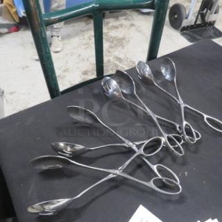 Stainless steel buffet tongs, six pieces, sleek design, good condition, suitable for serving, ideal for catering events.