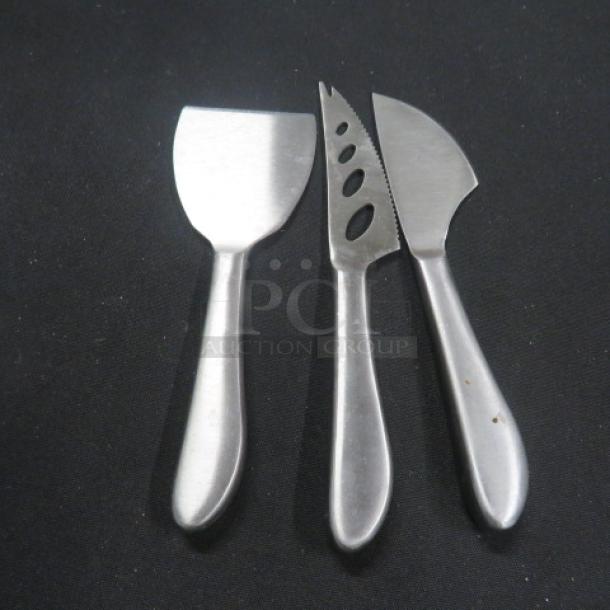 Set of 3 stainless steel cheese utensils, includes spreader, slicer, and knife; sleek design, good condition.