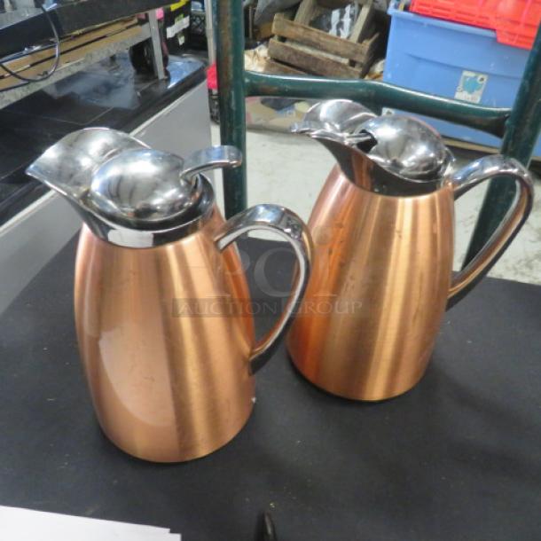 Copper coffee pot with lid, set of two, reflective finish, ergonomic handles, excellent condition.