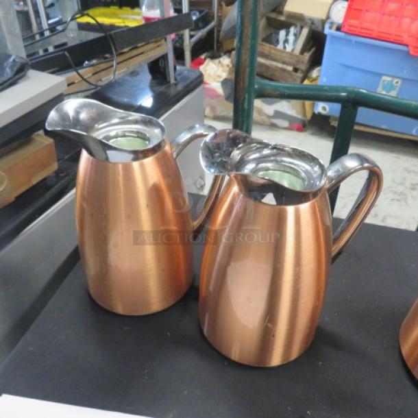 Copper coffee pots with polished finish and ergonomic handles. Reflective spouts, excellent condition, set of two.