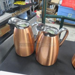 Copper coffee pots with polished finish and ergonomic handles. Reflective spouts, excellent condition, set of two.