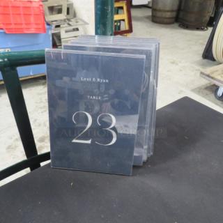Lot of 11 table menu holders, clear plastic, featuring "Lexi & Ryan" and large "Table 23" text. Good condition.
