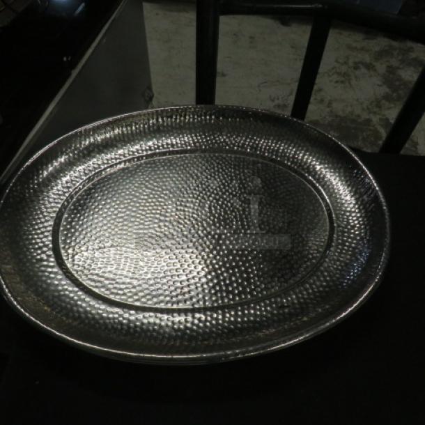17.5x13.5 stainless hammered platter, oval shape, shiny finish, excellent condition, textured design.