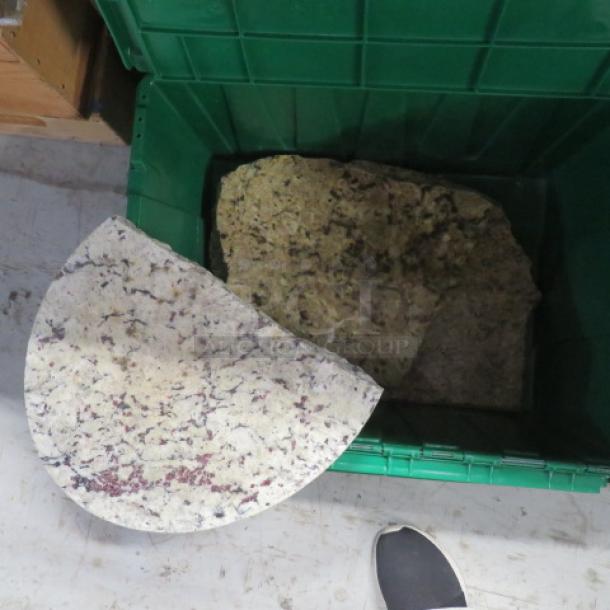 Assorted granite pieces in a green container, varying colors and patterns, shown in good condition.
