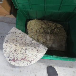 Assorted granite pieces in a green container, varying colors and patterns, shown in good condition.