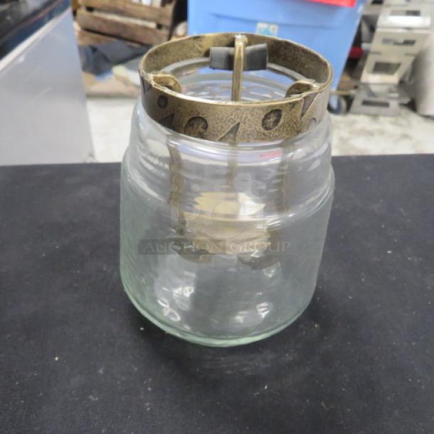 5-inch tall candle holder with a textured glass base and antique brass-like metal top, model 5XBID. Excellent condition.