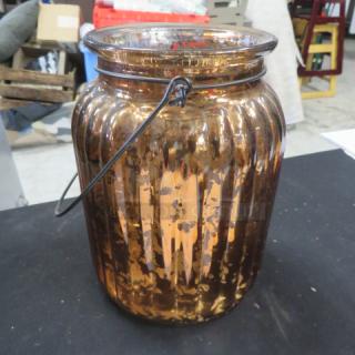 Gold glass candle holder with ribbed pattern and metal handle, labeled 3XBID. In good condition, suitable for decoration.