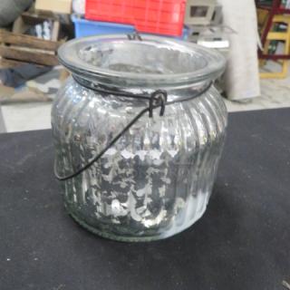 Silver candle holder with ribbed glass design. Features a metal handle. Good condition. Model 8XBID.