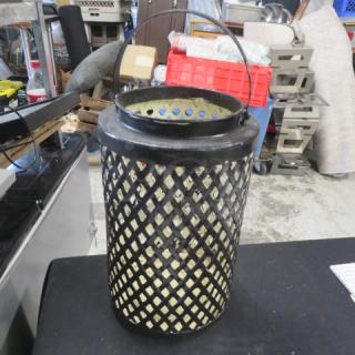 8x12 metal candle holder with lattice design, black finish, and handle. Good condition. Suitable for indoor or outdoor use.