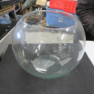 Round glass fish bowl, 11x9 inches, in good condition. Clear glass, no visible markings or labels. Ideal for decor or aquarium use.